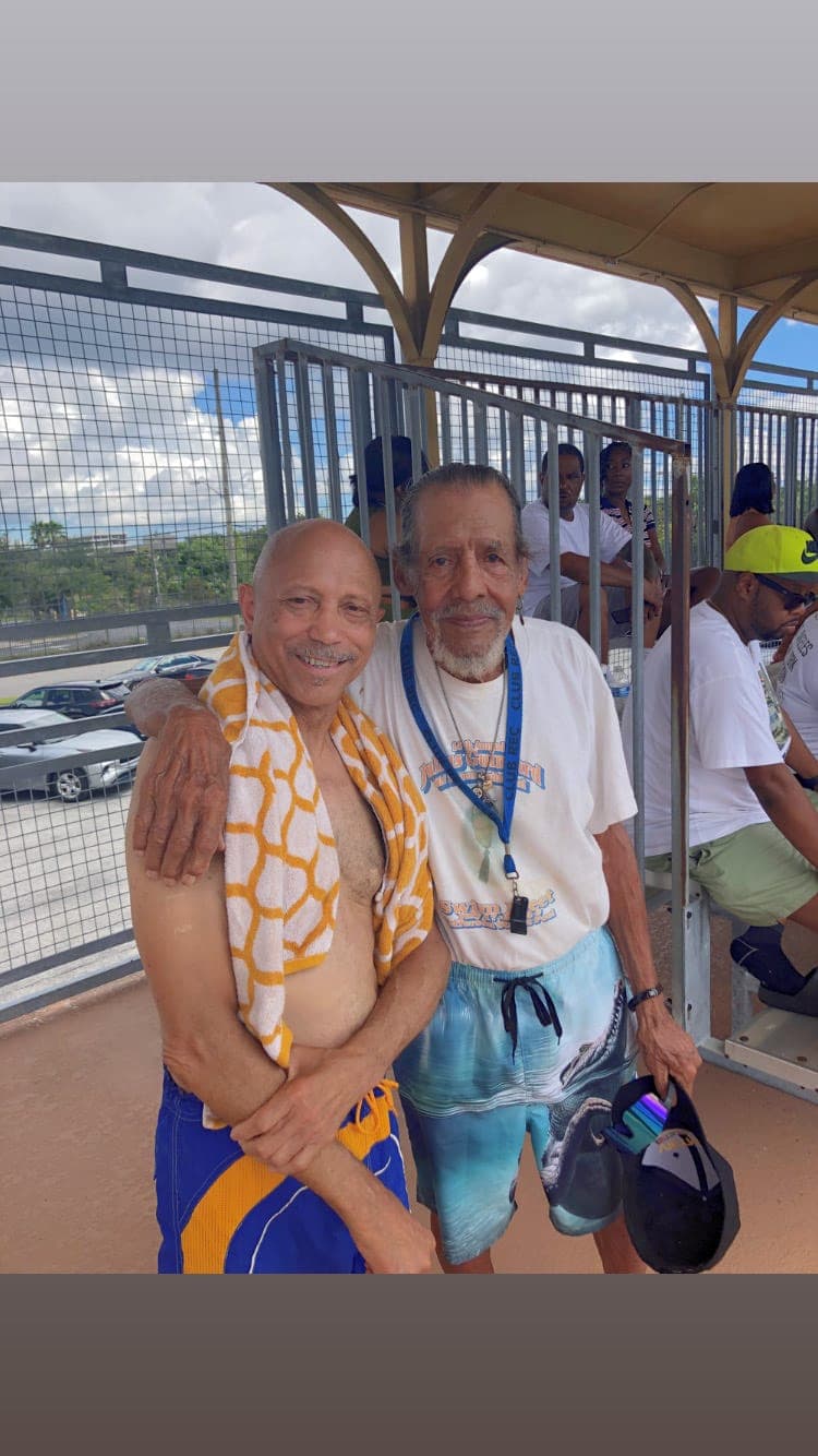 Two longtime friends sharing a moment poolside at the swim meet