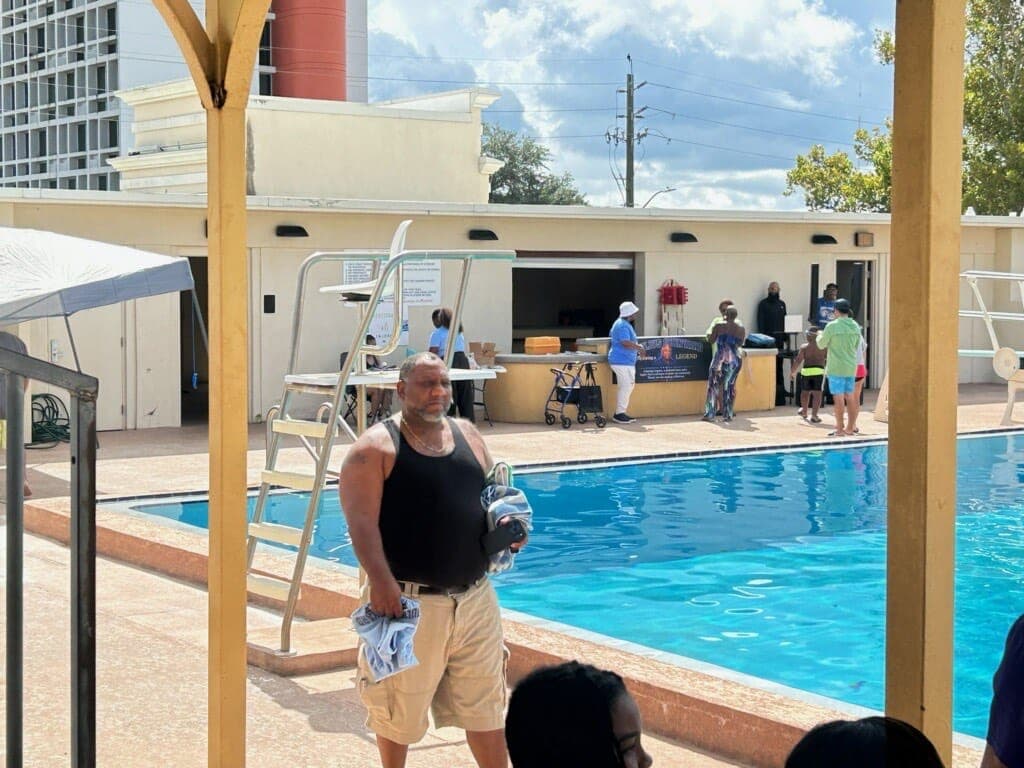A swimmer walking the pool deck during the meet